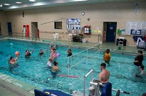 students playing water volleyball