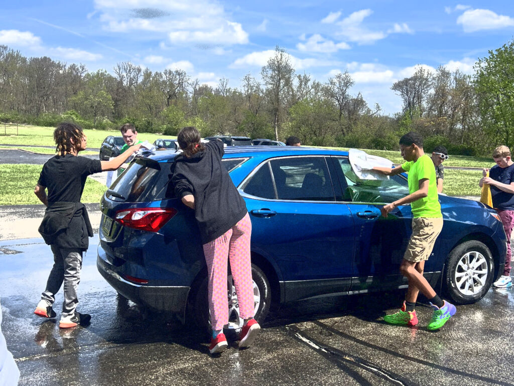 students wash a car for Sunrise Works program